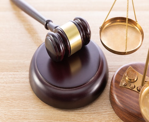 Wooden judges gavel on table in a courtroom